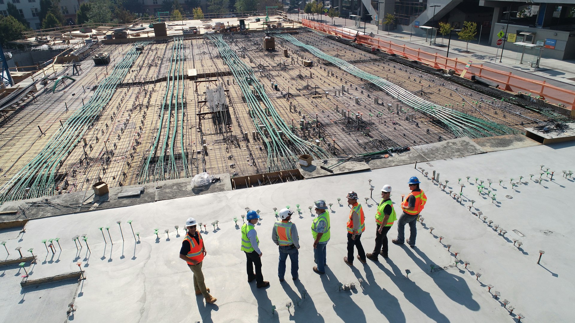 Construction worker measuring steel rod